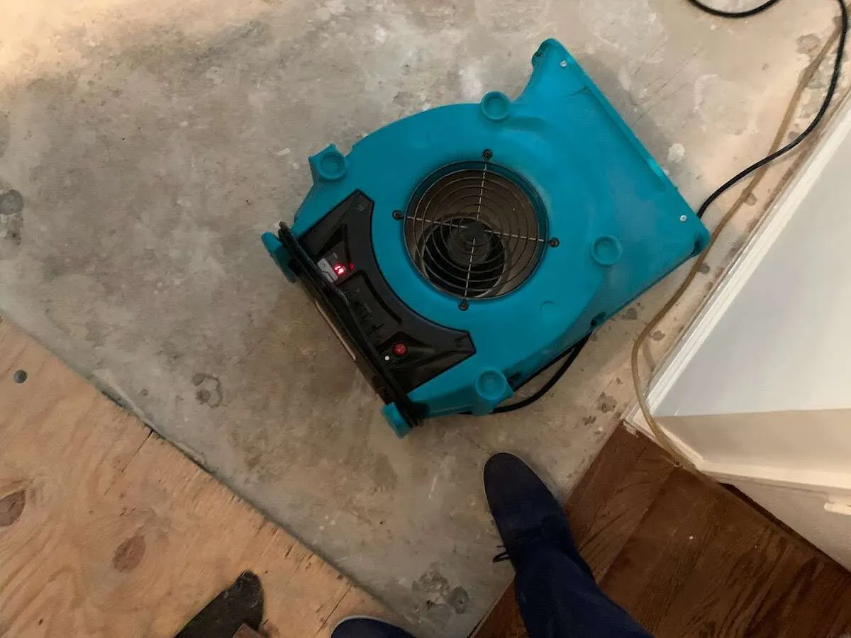 Air mover drying subfloor during Commercial Water Damage Restoration in Big Bear City